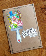 Kraft card with the paintbrush colored in blue with pink, yellow and purple blooms, hand drawn black border framing the panel and the sentiment stamped at the lower right with a small pink heart.