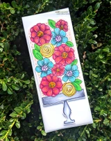 White slimline card with a stacked bouquet of pink and blue flowers on a grey cake stand, colored with bright markers.