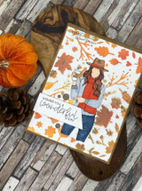 Card of the coffee girl among autumn leaves with a wonderful-day sentiment.
