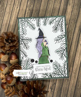 Green pine-bordered card with the purple witch, 'Happy Halloween brew-tiful.'