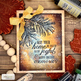 Dramatic card with a glowing gold pine bough over a dark background and 'May your home be filled with joyful memories.'