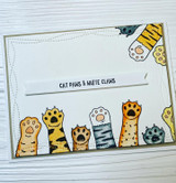 A row of patterned cat paws raised in the air with 'Talk to the paw' and 'You're paw-some,' a punny red rubber cat stamp set shown on a card.