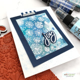 Card with the snowflake background inked in deep blue behind a 'Joy' die-cut word.