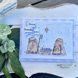 Soft blue card with the gnomes and manger on a pale watercolour panel with gold splatters and sleep in heavenly peace split across three banners.