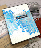 Card made with the Heart of Christmas dies — 'peace' and 'good tidings and joy' over a silver snowflake.