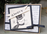 Card with the snowman on vintage sheet-music papers, 'all bundled up.'