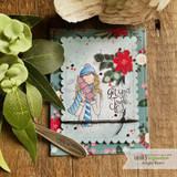 Festive scalloped card of the winter girl in a striped scarf holding a tree with 'get your jingle on'