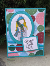 Teal polka-dot card with the girl in an oval frame and 'get your jingle on'