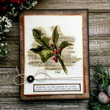 Rustic wood-panel card of the stamped holly with 'Wishing you the warmth of a cozy winter.'