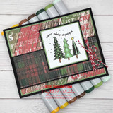 A row of patterned Christmas trees with 'merry merry christmas,' a petite itty bitty red rubber stamp shown on a holiday card.