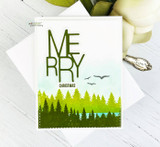 Card using the bundle: a layered evergreen forest with a bold 'MERRY Christmas.'