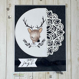 Black card of the deer in a white circle with a mandala accent and "simple joys."