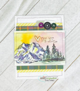 Layered mountains in a sunrise scene on a card trimmed with plaid washi strips.