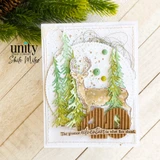 A buck among evergreen trees on a card with corrugated kraft and green accents.