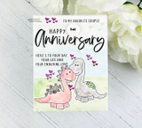 Mint card with two cuddling dinosaurs — 1st Happy Anniversary, here's to your enduring love