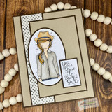Handmade card featuring the itty bitty planner girl in a cowboy hat and jean jacket, matted on kraft with wood beads, stamped with 'You are a brave & beautiful soul'.