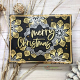 Black card of gold-embossed mandalas with the sample sentiment 'merry Christmas.'