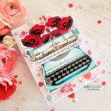 Soft pink card with ranunculus blooms and sequins, a mint typewriter with bright red poppies, and "I love the story we are writing together" stamped above it.