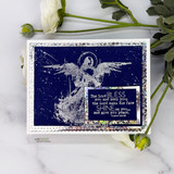 A nesting-die frame around a stamped angel on a distressed navy panel.