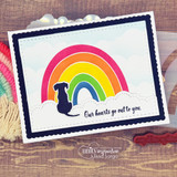 A nesting-die frame around a rainbow-and-dog scene on a navy card.
