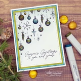 A stitched-rectangle die frame around a stamped ornaments scene, 'Season's Greetings.'