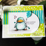 A scalloped die frame around a birthday penguin on a bright green card.