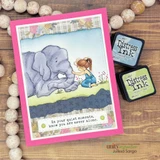 A stitched-rectangle die frame around an elephant-and-girl scene, 'in your quiet moments, know you are never alone.'