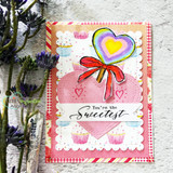 A rainbow heart lollipop on a cupcake-print card, captioned 'You're the Sweetest.'