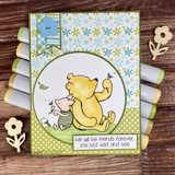 Circle-framed Pooh and Piglet card on green floral patterned paper with the friends-forever sentiment banner.