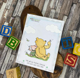 Pooh and Piglet under stamped clouds with alphabet blocks around a 'We will be friends forever' card.