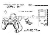 Line-art stamp sheet of retro game controllers and a handheld console with sentiments 'congratulations on your level up,' 'enjoy the birthday loot' and 'you're vintage.'
