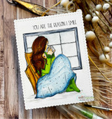 Handmade card featuring the AngieGirl curled at a window in a cozy blanket, shown as two friends in blankets, stamped with 'Let your soul wander'.