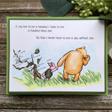 Soft card with Pooh and Piglet on a breezy hillside, both quote sentiments stamped in the sky above them.
