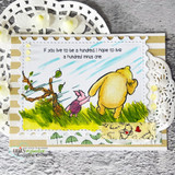 Card of Pooh and Piglet walking into the wind on a gold-striped mat with the full 'hundred minus one' quote.