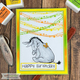 Happy Birthday card of Eeyore under colorful string confetti swags with lime green frame.
