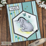 Hugs card of Eeyore with a butterfly on teal striped and dotted papers.