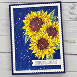 Golden sunflowers colored and popped on a navy splatter-painted panel inside a white scalloped frame.