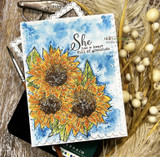 Watercolored sunflowers on a blue-washed panel with a gratitude sentiment on the sample card.