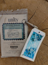 Product packaging photo of the Butterfly Moment slimline red rubber stamp set with a blue shaker tag.