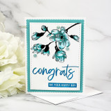 Teal magnolia branch on a stitched white panel with a teal scalloped mat and the sentiment 'congrats on your happy day'