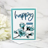 Teal magnolia blooms on a white panel with a teal scalloped frame and the sentiment 'happy birthday'