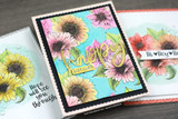 The blooms in bright colors on a teal card with a gold 'happy' die-cut.