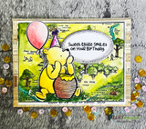 Card with Pooh, a party hat and red balloon on the Hundred Acre Wood map: 'Sweet little smiles on your birthday.'