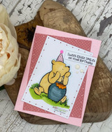 Pink card with party-hat Pooh and his honey pot: 'Sweet little smiles on your birthday.'