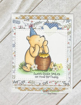 Card with party-hat Pooh and his honey pot on plaid: 'Sweet little smiles on your birthday.'