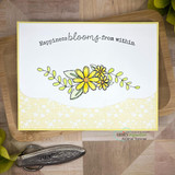 Daisy swag in yellow on a soft yellow card, 'Happiness blooms from within.'