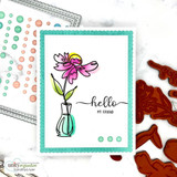 White panel with a pink and yellow daisy in a clear bud vase, hello my friend in script beneath it, mounted inside a bright teal scalloped frame.