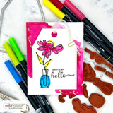 Tag style card with a magenta daisy in a blue vase over a hot pink watercolor wash, with a very warm hello lettered below.