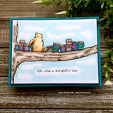 Teal box card of classic Pooh on a branch of honey jars under a blue stamped sky