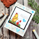 Heart-embossed card with Pooh and Piglet among hearts and the friendship quote.